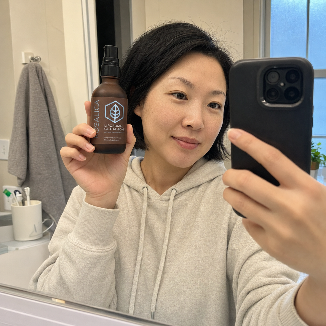 Person holding Rosalica Liposomal Glutathione